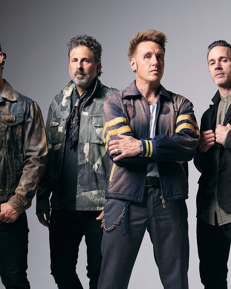 Papa Roach, four members in denim and leather against a plain white backdrop, the official band photo