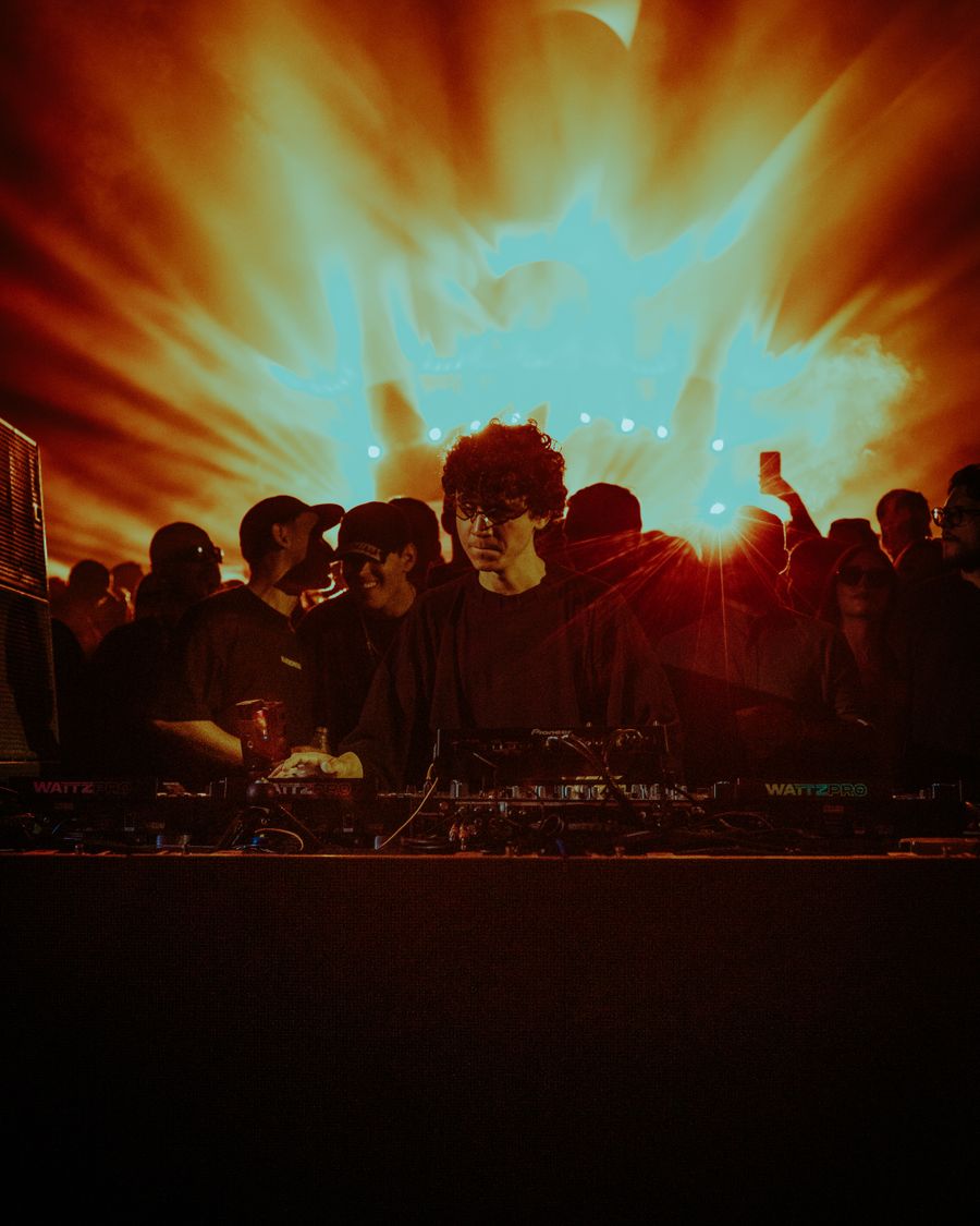 Rave crowd lit by orange and blue strobe lights
