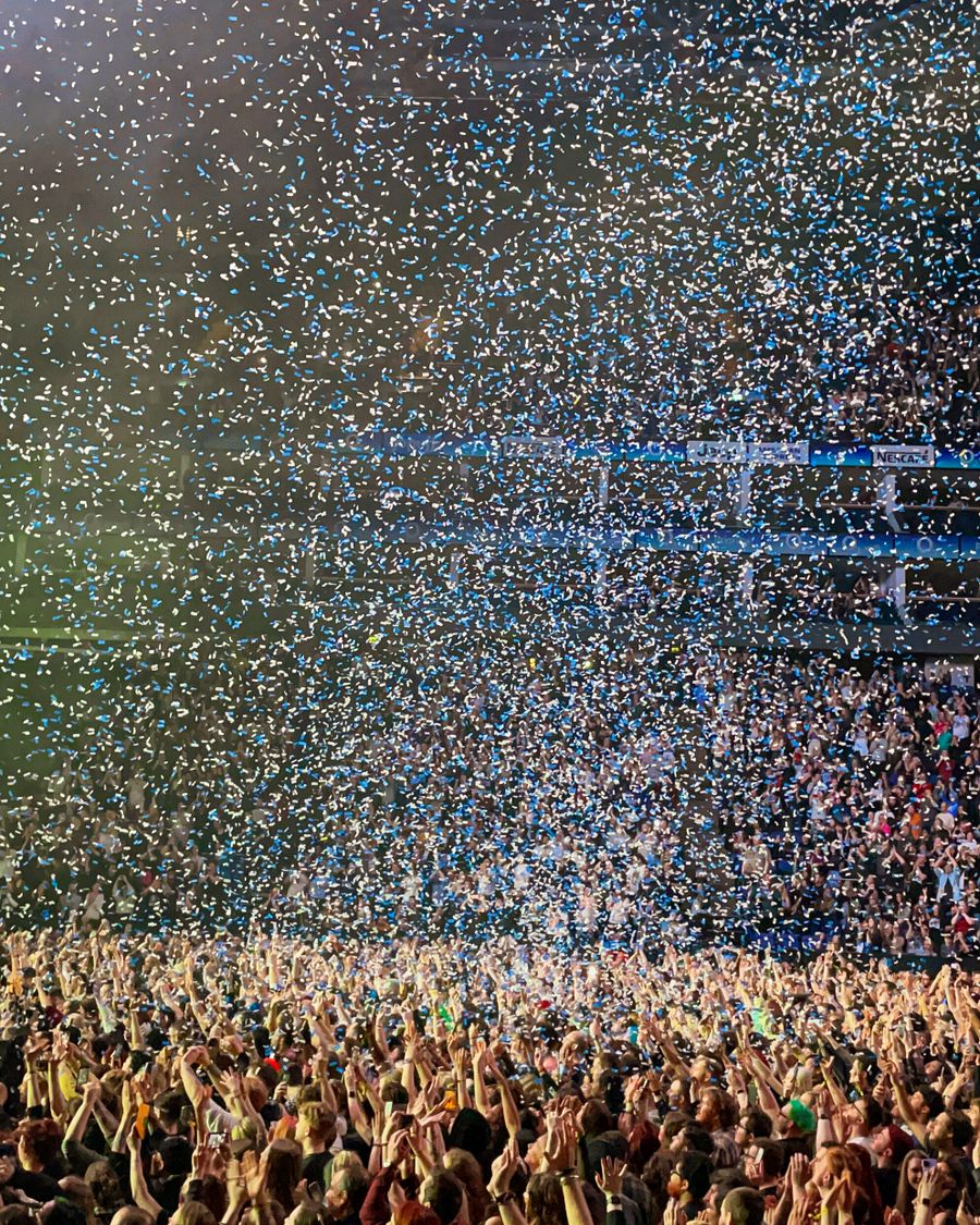Confetti falling over an arena crowd