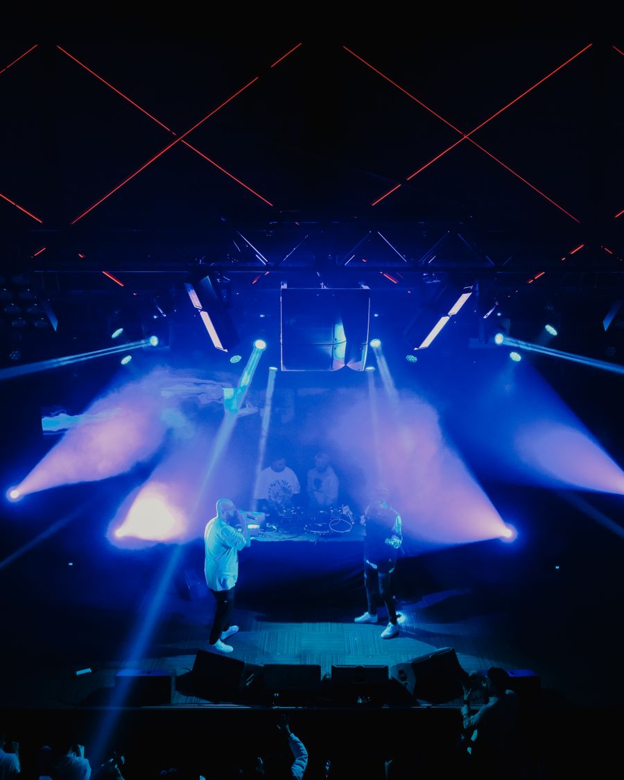 Smoke and blue beams over a concert stage