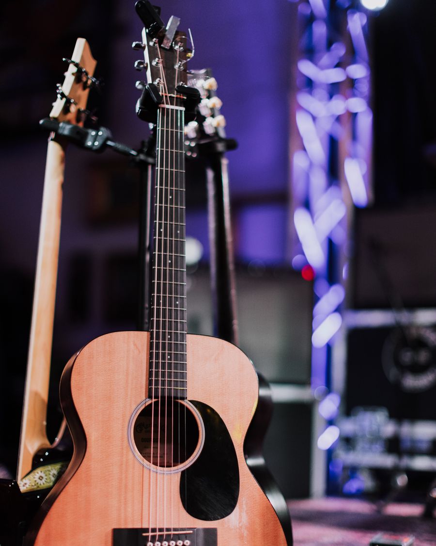 Acoustic guitars resting backstage before a show