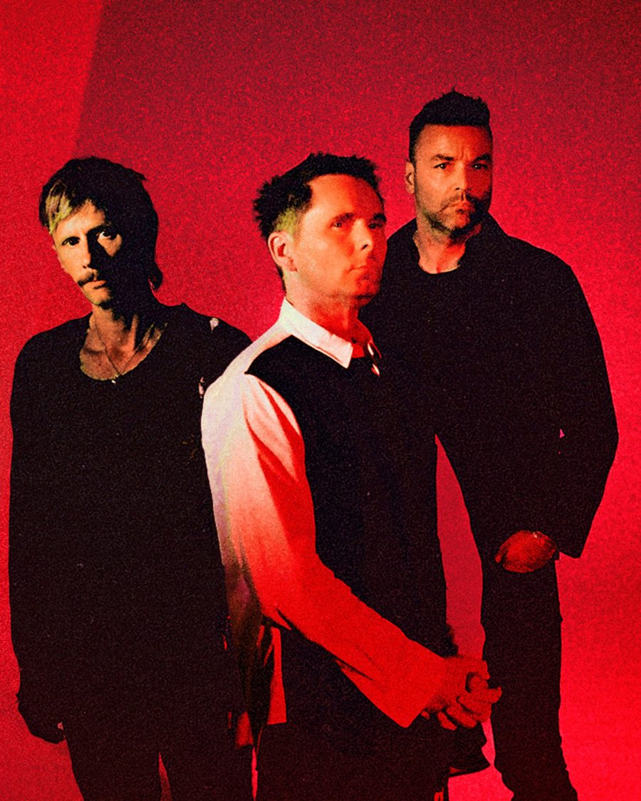 Muse, the three members standing in red light - the official Wow! Signal Europa Tour image
