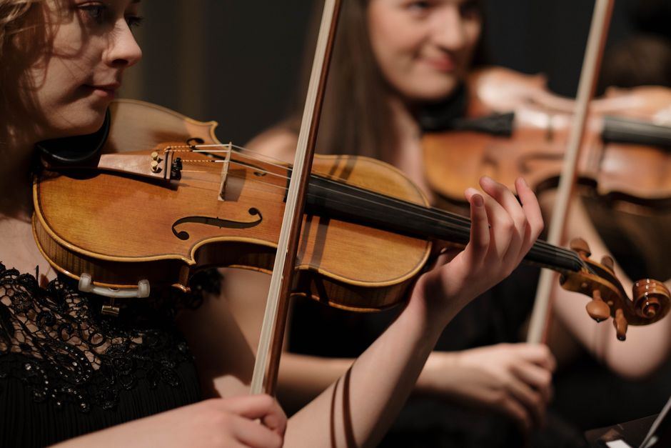A close-up of a violinist mid-performance