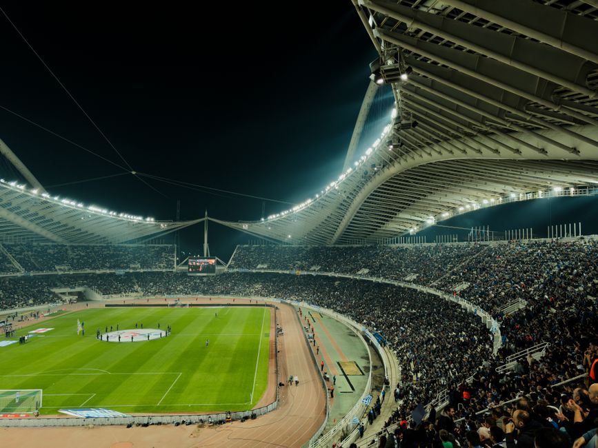 A packed football stadium lit up at night