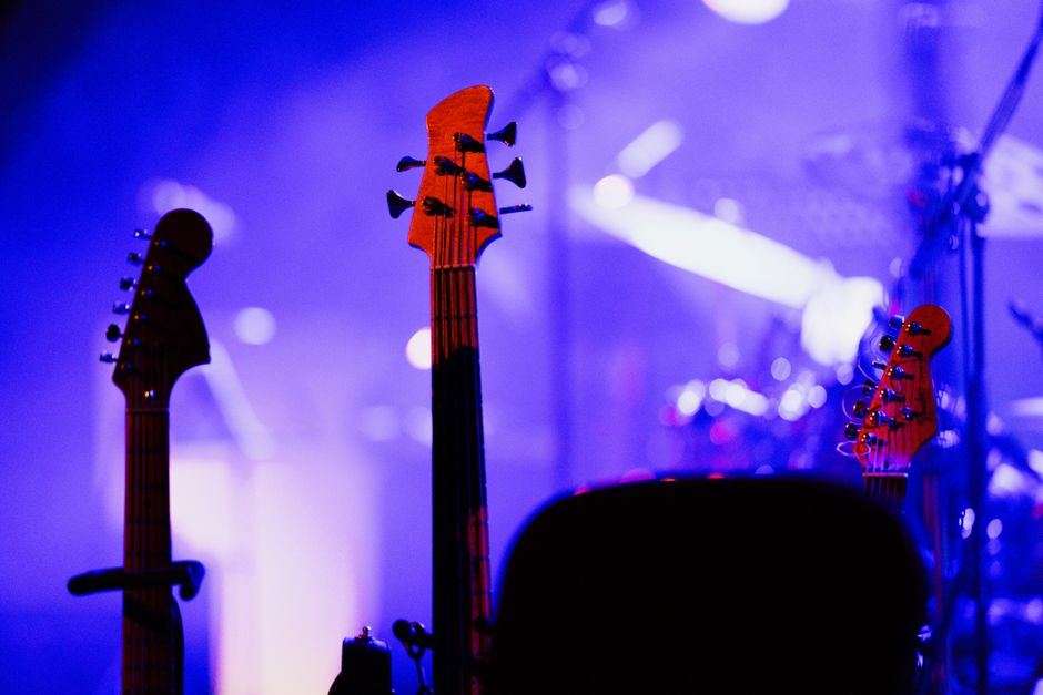 Electric guitars on stage under purple stage lighting